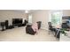 Cozy living room with plenty of space, a ceiling fan, and multiple windows for natural light at 106 Roundtop Rd, Cary, NC 27519