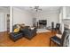 Comfortable living room featuring hardwood floors, a sleek fireplace, and a modern sectional at 106 Roundtop Rd, Cary, NC 27519
