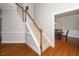 Classic staircase with wood railing and carpeted steps, leading to the upper level of the home at 106 Roundtop Rd, Cary, NC 27519