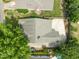 Aerial view of a single-Gathering home, with a concrete driveway and backyard surrounded by mature trees at 107 Covington Dr, Chapel Hill, NC 27514