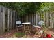 Secluded seating area with classic chairs and table surrounded by lush landscaping at 107 Covington Dr, Chapel Hill, NC 27514