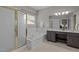 Bathroom with a tub, shower with glass doors, double sink vanity with dark wood cabinets at 107 Covington Dr, Chapel Hill, NC 27514