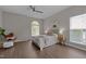 Bedroom features wood floors, ceiling fan, arched window, and a neutral color palette at 107 Covington Dr, Chapel Hill, NC 27514