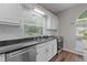 Bright kitchen features a window above the sink, white subway tile backsplash, and stainless steel appliances at 107 Covington Dr, Chapel Hill, NC 27514