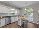 Modern kitchen featuring white cabinets, stainless steel appliances, and a butcher block island at 107 Covington Dr, Chapel Hill, NC 27514