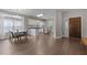 Open-concept kitchen with dining area, white cabinets, and stone backsplash at 107 Covington Dr, Chapel Hill, NC 27514