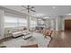 Bright living room featuring a fireplace, ceiling fan, hardwood flooring, and natural light at 107 Covington Dr, Chapel Hill, NC 27514