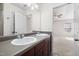 Bathroom with double sinks, wood cabinets, and large mirror at 109 Citrine Ct, Durham, NC 27703