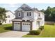 Beautiful home featuring a two-car garage, manicured lawn, and charming architectural details at 109 Citrine Ct, Durham, NC 27703
