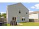 Home backyard features a patio, grill, Adirondack chairs, and well-manicured lawn at 110 Bray Dr, Mebane, NC 27302