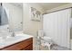 Bathroom featuring a vanity, toilet, and shower tub with a curtain at 110 Bray Dr, Mebane, NC 27302