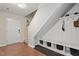Inviting entryway featuring a coat rack with hooks and a built-in bench with storage beneath the staircase at 110 Bray Dr, Mebane, NC 27302