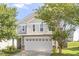 View of a charming two-story home with a two-car garage and well-maintained lawn at 110 Bray Dr, Mebane, NC 27302