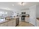 Open kitchen featuring stainless steel appliances, granite countertops, and white cabinets at 110 Bray Dr, Mebane, NC 27302
