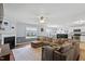 Spacious living room featuring a cozy fireplace, comfortable seating, and an open floor plan leading into the kitchen at 110 Bray Dr, Mebane, NC 27302