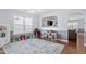 Play area featuring a blue rug, window, and an open view into the living room at 110 Bray Dr, Mebane, NC 27302