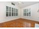 Neutral bedroom has hardwood floors, vaulted ceilings, and multiple windows with plantation shutters at 11005 Louson Pl, Raleigh, NC 27614