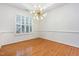 Open dining room with modern lighting, hardwood floors, crown molding, and plantation shutters at 11005 Louson Pl, Raleigh, NC 27614