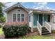 Home exterior featuring a sunroom, manicured landscaping, and a private backyard at 11005 Louson Pl, Raleigh, NC 27614