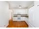 Well lit Kitchen has white appliances, granite counters, hardwood floors and white cabinets at 11005 Louson Pl, Raleigh, NC 27614