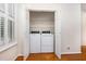 Laundry area with shelving and a full-sized washer and dryer, all located behind folding doors at 11005 Louson Pl, Raleigh, NC 27614