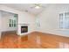 Living room with hardwood floors, fireplace, vaulted ceiling, plantation shutters, and natural light at 11005 Louson Pl, Raleigh, NC 27614