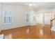 Bright living room with hardwood floors, plantation shutters, vaulted ceiling, and open floor plan at 11005 Louson Pl, Raleigh, NC 27614