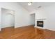 Spacious living room featuring hardwood floors, fireplace, vaulted ceiling, and natural light at 11005 Louson Pl, Raleigh, NC 27614
