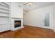 Living room with vaulted ceiling, ceiling fan, hardwood floors, fireplace and built in shelving at 11005 Louson Pl, Raleigh, NC 27614