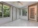 Screened in porch with ceiling fan, tile floor and access to the exterior at 11005 Louson Pl, Raleigh, NC 27614