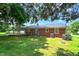 Spacious backyard features a deck, mature trees, and well-maintained lawn for outdoor enjoyment at 111 Dee Long Rd, Roxboro, NC 27574