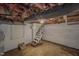 Unfinished basement area with brick fireplace and access to the main floor at 111 Dee Long Rd, Roxboro, NC 27574