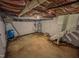 Unfinished basement offering utilities, concrete floor and brick fireplace at 111 Dee Long Rd, Roxboro, NC 27574