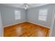 Cozy bedroom featuring wood floors, ceiling fan, and natural light at 111 Dee Long Rd, Roxboro, NC 27574