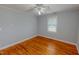 Neutral bedroom featuring wood floors, ceiling fan and one window with blinds at 111 Dee Long Rd, Roxboro, NC 27574