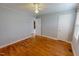 Neutral bedroom featuring wood floors and doors with passage to another room at 111 Dee Long Rd, Roxboro, NC 27574