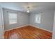 Neutral bedroom featuring wood floors and two windows with natural light at 111 Dee Long Rd, Roxboro, NC 27574