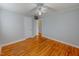 Comfortable bedroom with a ceiling fan and wood floors at 111 Dee Long Rd, Roxboro, NC 27574