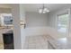 Cozy dining area features tiled floors, a classic chandelier, and scenic views at 111 Dee Long Rd, Roxboro, NC 27574