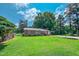 Beautifully maintained property with lush green lawn, mature trees, and charming brick facade at 111 Dee Long Rd, Roxboro, NC 27574