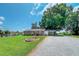 Charming brick home with lush green lawn and spacious driveway, great for outdoor activities at 111 Dee Long Rd, Roxboro, NC 27574