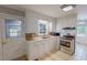 Well-lit kitchen features classic white cabinets, tile countertops, and modern stainless steel appliances at 111 Dee Long Rd, Roxboro, NC 27574