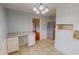 Kitchen area featuring a built-in desk, tiled flooring, and stainless steel refrigerator at 111 Dee Long Rd, Roxboro, NC 27574