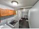 Functional laundry room with painted brick, overhead cabinets and modern washer and dryer at 111 Dee Long Rd, Roxboro, NC 27574