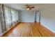 Spacious living room with hardwood floors and large windows allowing ample natural light at 111 Dee Long Rd, Roxboro, NC 27574