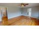 Hardwood floors, light gray walls, and adjacent rooms create a spacious feeling in this charming living area at 111 Dee Long Rd, Roxboro, NC 27574