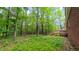 Wooded backyard offers privacy with a deck, ready for outdoor enjoyment at 1116 Little Creek Rd, Durham, NC 27713