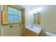 Bright bathroom featuring a window with shutters and classic fixtures at 1116 Little Creek Rd, Durham, NC 27713