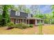 A beautiful two-story home featuring a combination of brick and light blue siding, nestled among tall trees at 1116 Little Creek Rd, Durham, NC 27713