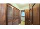 Hallway featuring laundry closet with louvered doors and an adjacent bathroom, combining convenience and functionality at 1116 Little Creek Rd, Durham, NC 27713